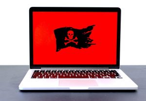 skull and crossbones on red background on laptop